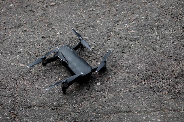 Black drone on asphalt