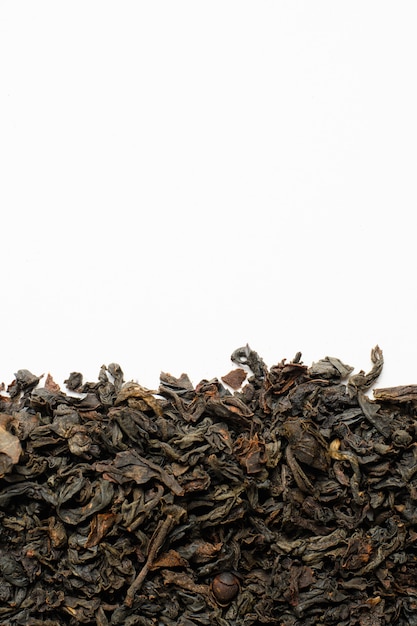 Black dry tea on a white background. Copy space.