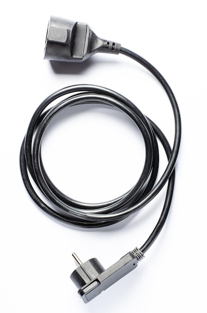 Black electric extension cord on a white background Closeup