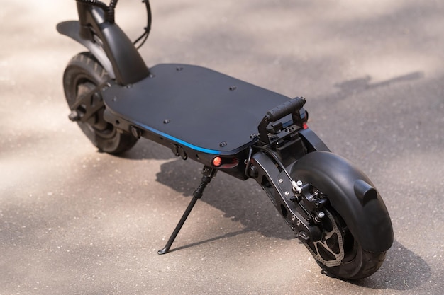 Black Electric scooter standing on the running board on the street