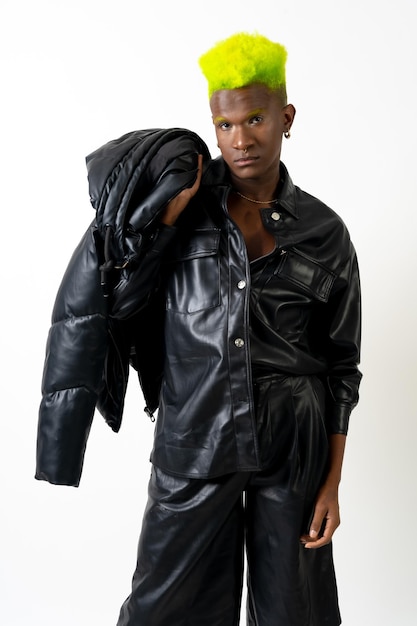 Black ethnic man in studio with white background LGTBI concept leather jacket