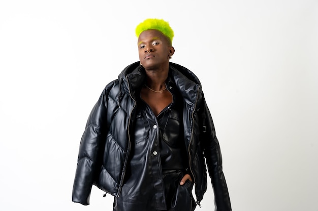 Black ethnic man in studio with white background LGTBI concept posed with the leather jacket