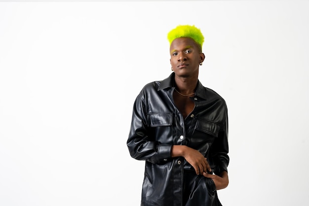 Black ethnicity man in studio with white background LGTBI concept fashion posed with black jacket