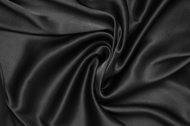 Black fabric texture background wavy fabric slippery black color luxury satin cloth texture