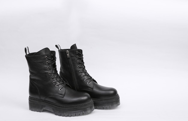 Black Fashionable highsoled leather boots on white background