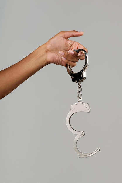 Black female hand showing handcuffs