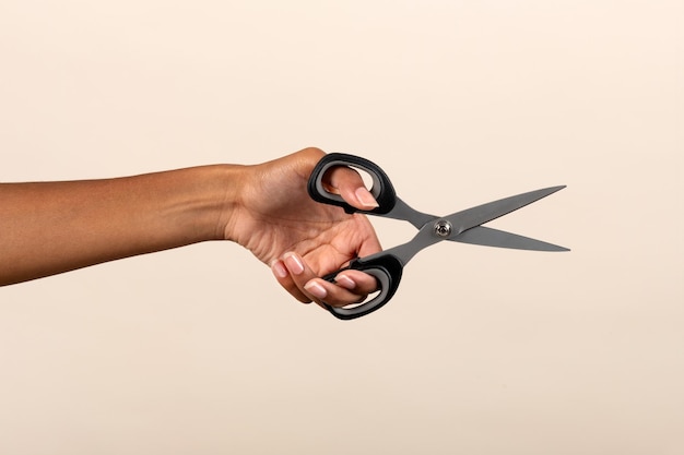 Black female hand with scissors