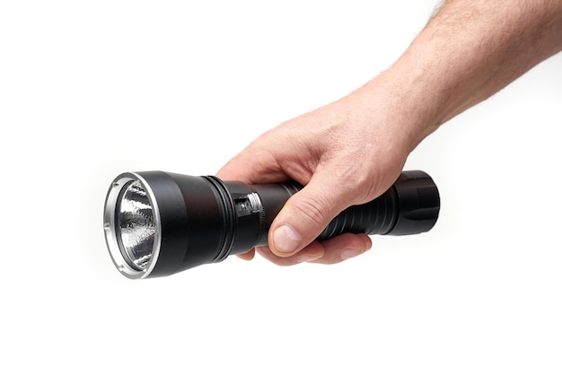 Black flashlight in hand on a white background