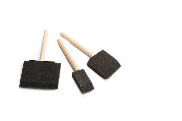 Black foam brushes on a white background with copy space