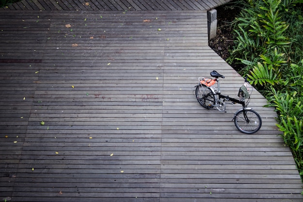 Black folding bike on the wood bridge