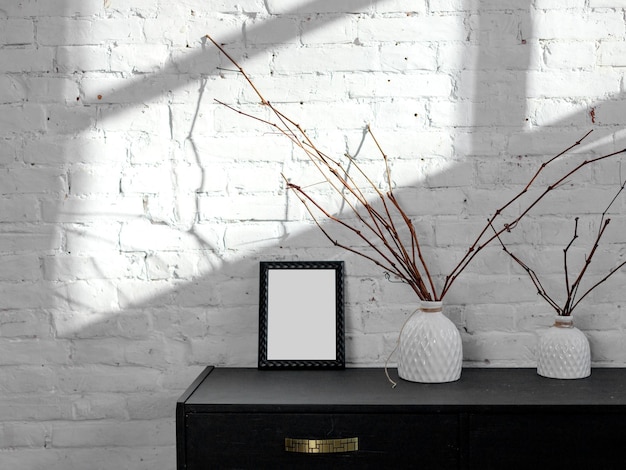 Black frame on a tusba against a white brick wall sunlight interior