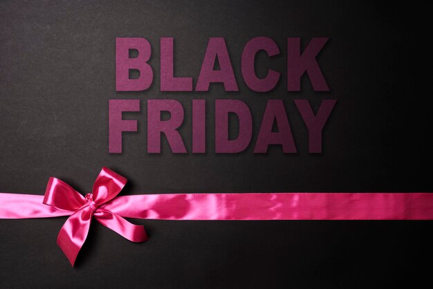 Photo black friday concept black friday sale on dark background colored ribbons on black