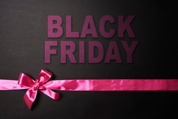 Photo black friday concept black friday sale on dark background colored ribbons on black