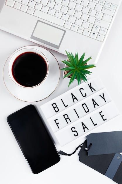 Black Friday concept Laptop and coffee cup on white background Online sale