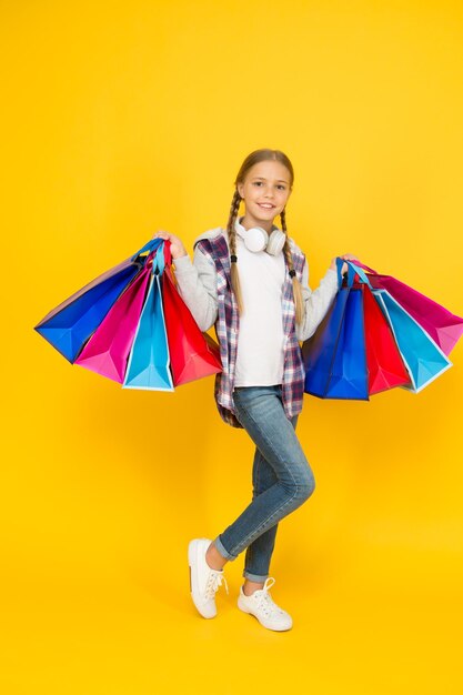 Black friday hurry up its total sale Kids fashion Sales and discounts happy small girl after successful shopping adorable child with heavy bags Best outfit ever holiday gifts in packages