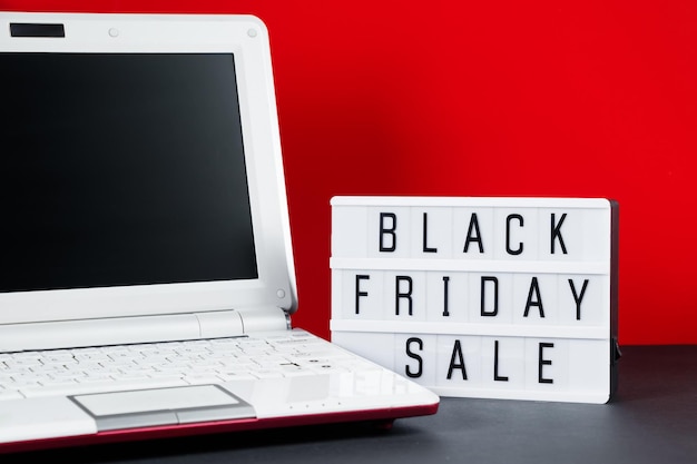 Black Friday online sale concept Notebook on red background