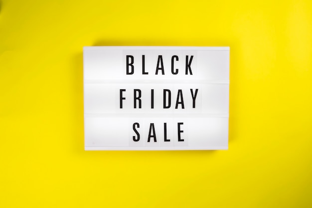 Black friday sale message on lightbox on yellow background sales concept