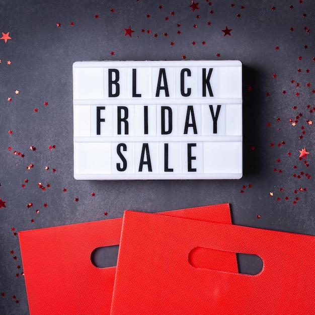 Photo black friday sale pattern with red boxes and shopping bags