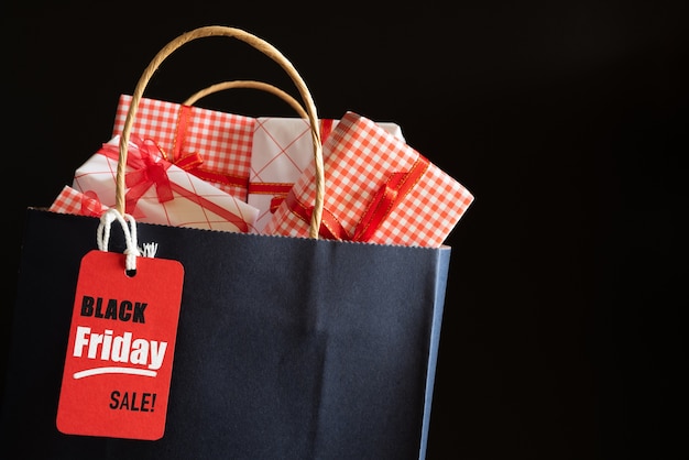 Black Friday Sale shopping bag and gifts boxes with message tag. shopping concept