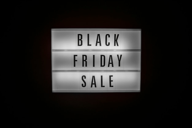 Black friday sale text on illuminated lightbox in dark sales concept