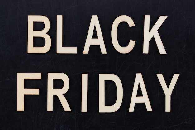 Black Friday - text in wooden letters on blackBoard. Copy space.