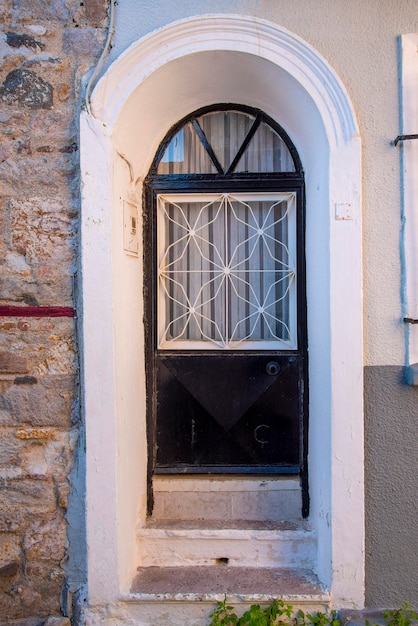 The black front door of the old brick building