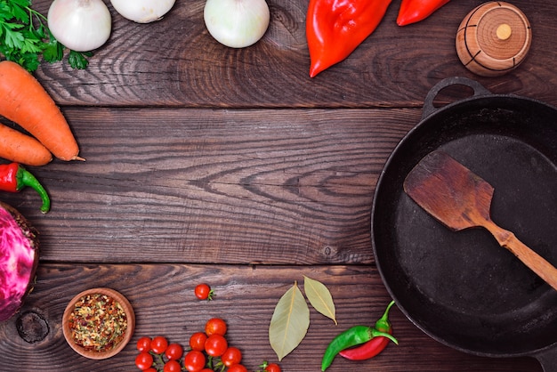 Black frying pan and fresh vegetables 