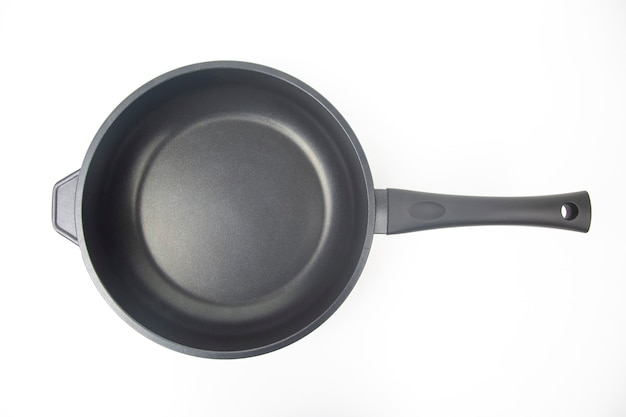 Black frying pan with non-stick teflon coating on white