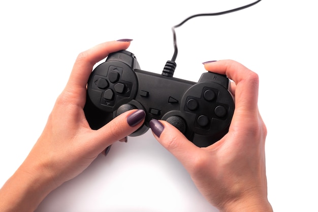 Black gamepad in female hands on a white background