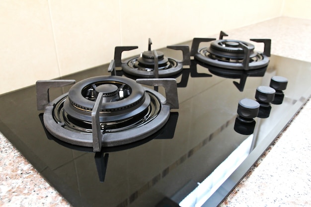 Black glass gas hob in kitchen