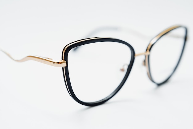 Black glasses on a white background, hipster style, plastic frames, the concept of poor vision