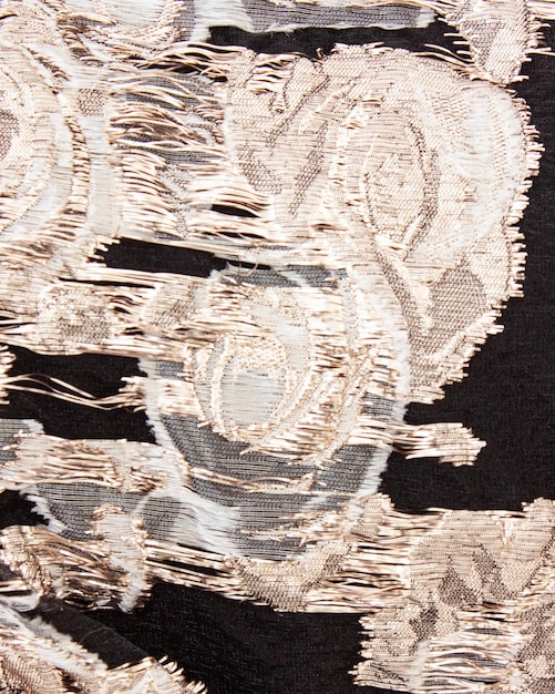 A black and gold floral pattern fabric with a floral pattern.