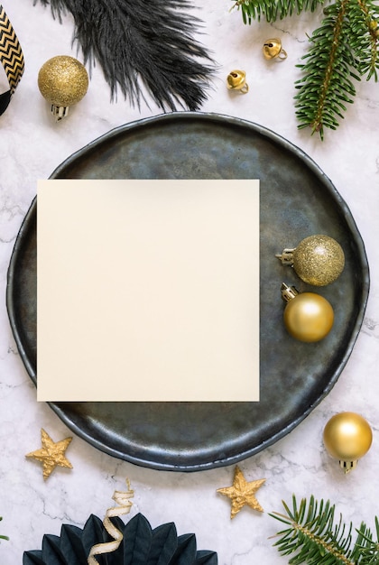 Black and golden Christmas Table setting with a card ornaments and fir tree branches Mockup