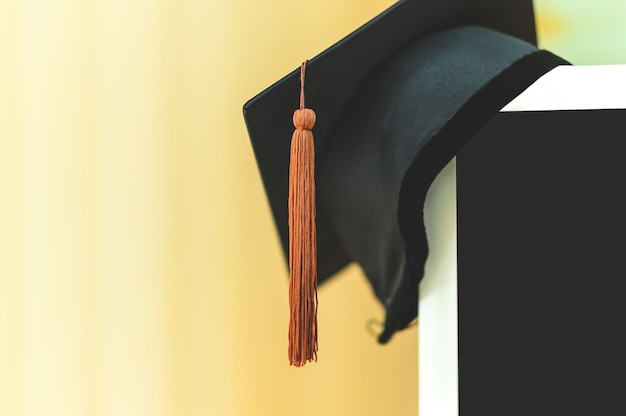 Black graduation cap placed on a computer monitor