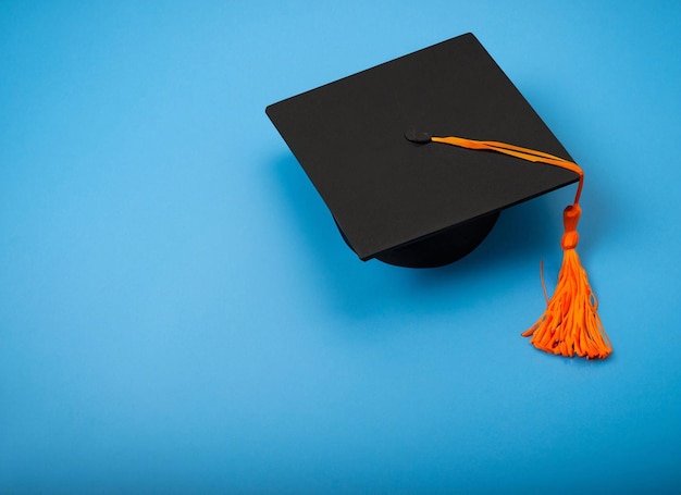 A black graduation cap with a tassel that says'cap'on it