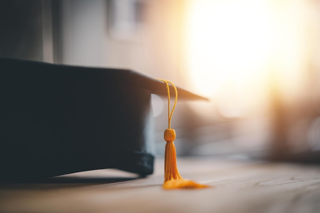 Black Graduation Hat placed on wooden board