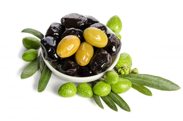 Black and green olives in a bowl isolated on white background