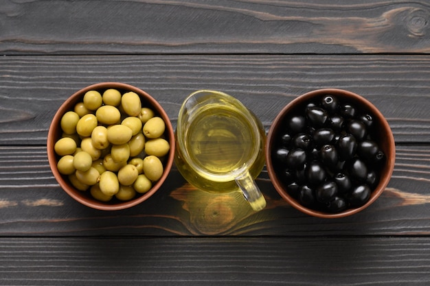 Black and green olives on a dark wooden rustic background