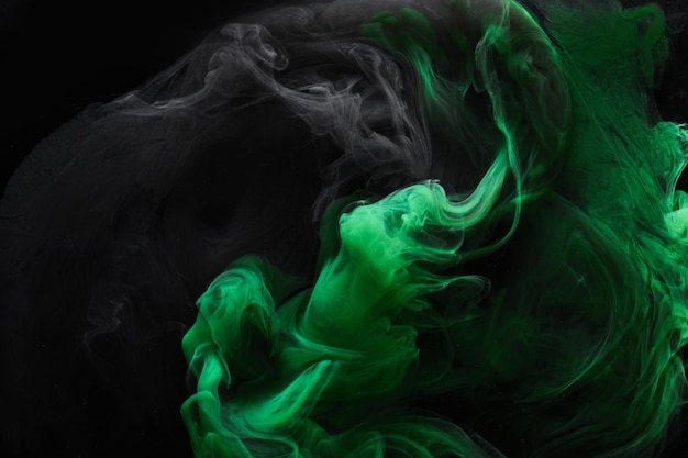 Black green smoke abstract background acrylic paint underwater explosion swirling ink