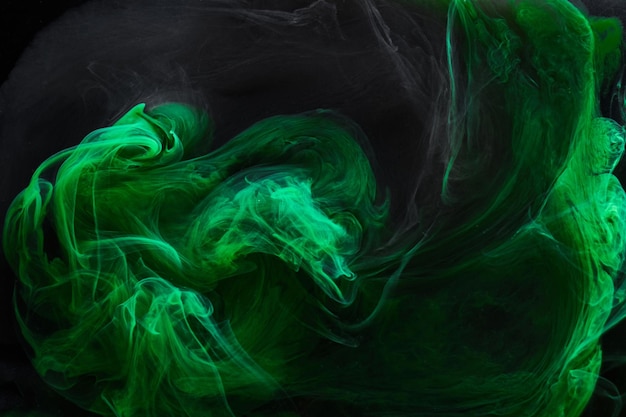 Black green smoke abstract background acrylic paint underwater explosion swirling ink