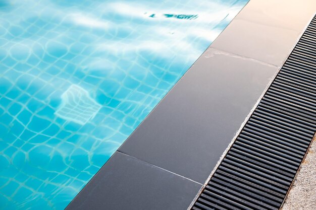 Photo black gutter is installed beside swimming pool drainage system overflow gutter private pool pool edge