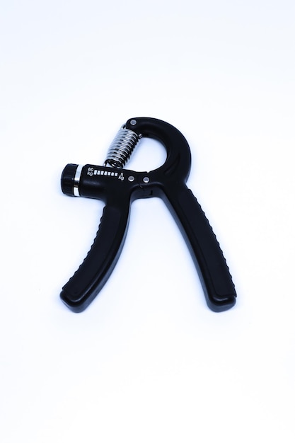 A Black Hand Grip Exercise Tool with Top Shot in The White Background, Portrait Mode and Minimalist