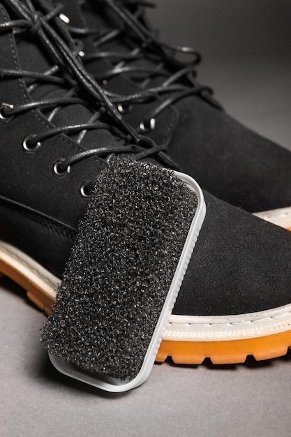 Black hard sponge next to suede black winter boots