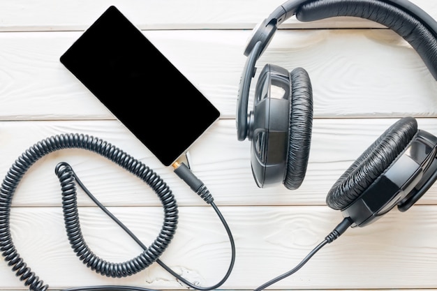 Black Headphones and smartphone on a white background