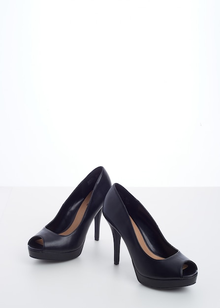 Black high-heeled shoes on white