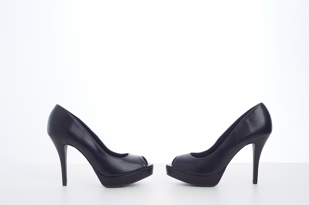 Black high-heeled shoes on white