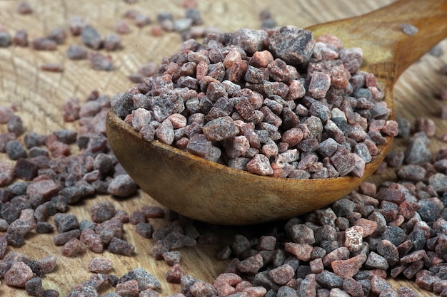 Black Himalayan salt in a wooden spoon on the table