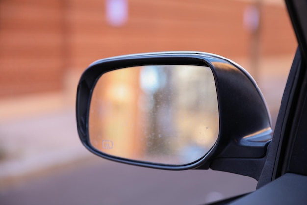 A black honda civic has a mirror that says'i'm a driver '