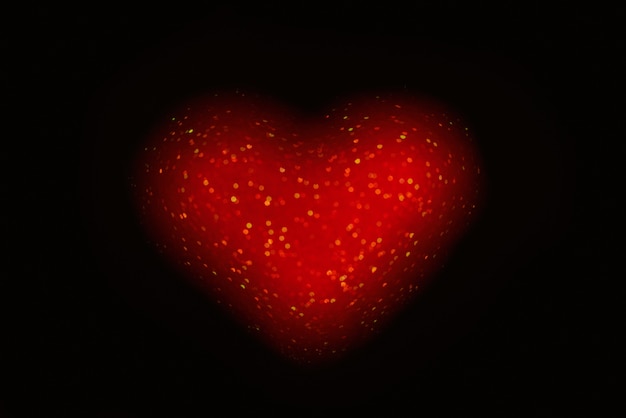 On black isolated background red defocused heart from.