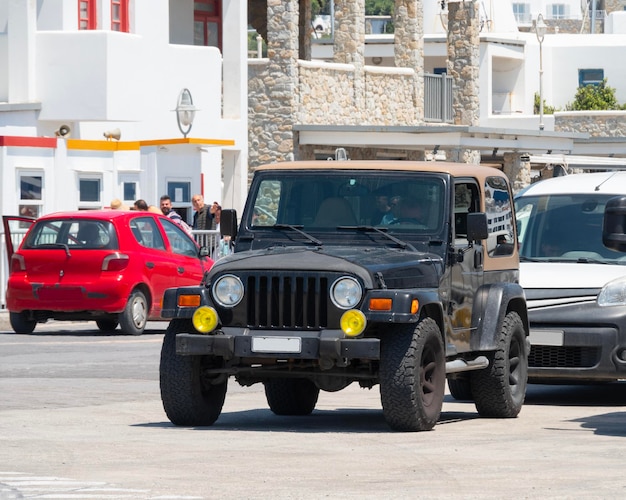 Black jeep 4x4 in the port of Mykonos island in Greece